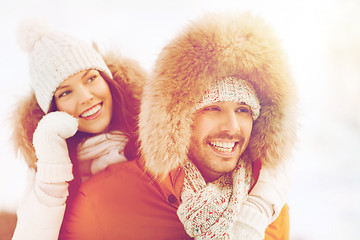 Image showing happy couple having fun over winter background