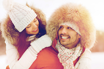 Image showing happy couple having fun over winter background