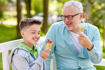 Image showing old man and boy eating ice cream at summer park