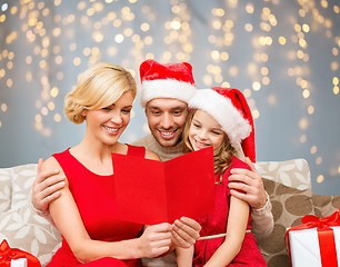 Image showing happy family reading christmas postcard