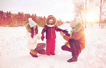 Image showing happy family with child in winter clothes outdoors