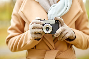 Image showing close up of woman with camera in autumn park