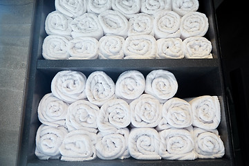 Image showing rolled white bath towels at hotel spa