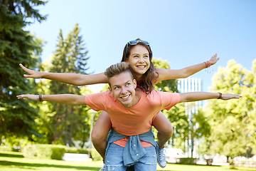 Image showing happy teenage couple having fun at summer park