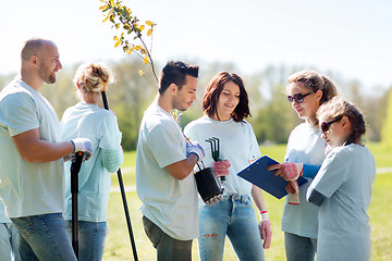 Image showing group of volunteers planting trees in park