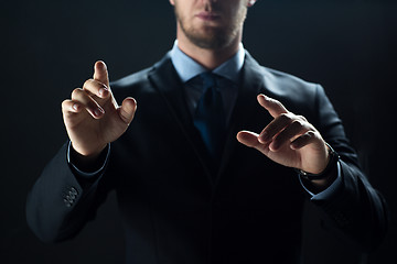 Image showing close up of businessman touching virtual screen