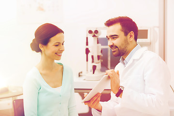 Image showing optician with tablet pc and patient at eye clinic