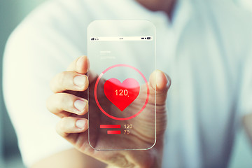 Image showing close up of hand with heart rate on smartphone