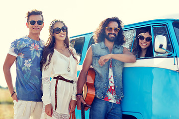 Image showing smiling young hippie friends over minivan car