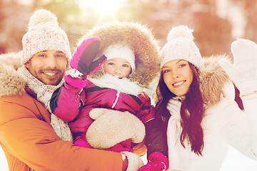 Image showing happy family waving hands outdoors in winter