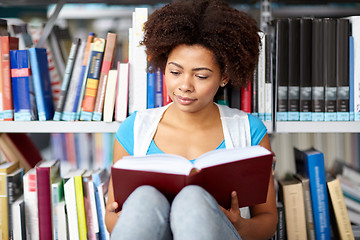 Image showing african student girl reading book at library