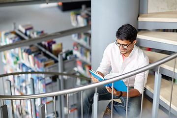 Image showing hindu student boy or man reading book at library