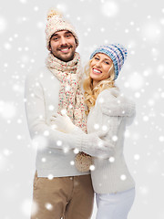 Image showing smiling couple in winter clothes hugging