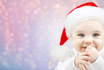 Image showing happy baby in santa hat over holidays lights