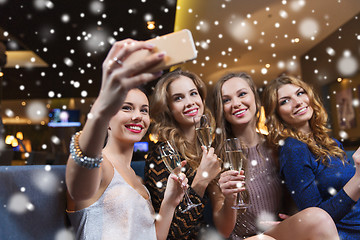 Image showing women with champagne taking selfie at night club