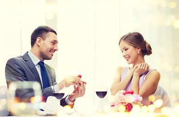 Image showing man proposing to his girlfriend at restaurant