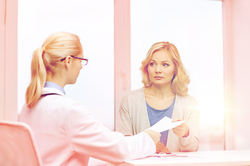 Image showing doctor giving prescription to woman at hospital