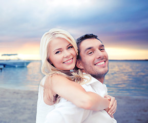 Image showing couple having fun and hugging on beach