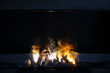 Image showing flame of firewood burning in modern fireplace