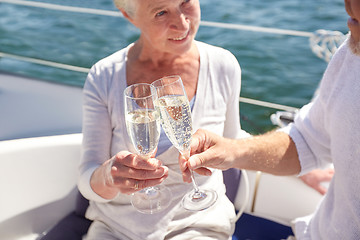 Image showing close up of senior couple with champagne on boat