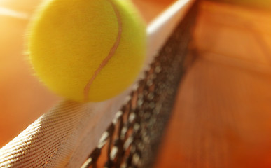 Image showing Tennis ball hitting the net