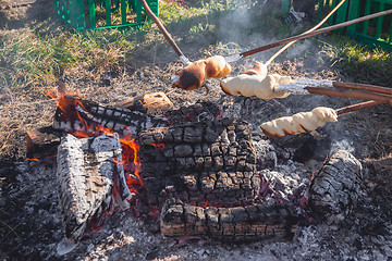 Image showing Homemade bread baked over a bonfire