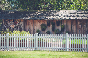 Image showing White picket fence in a garden