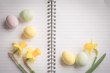 Image showing Daffodils and easter eggs on paper
