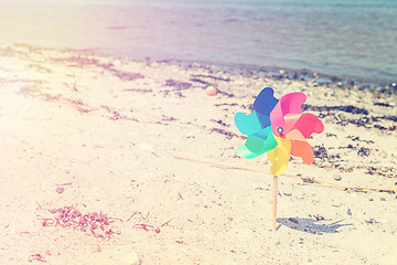 Image showing Wind mill toy on a beach