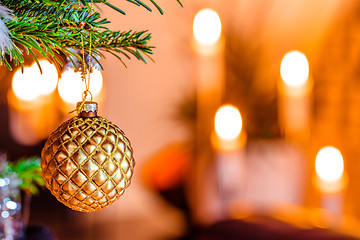 Image showing Golden bauble on a Christmas tree
