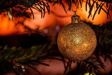 Image showing Golden Christmas bauble with glittering lights