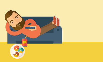 Image showing Man lying in the sofa holding a remote.