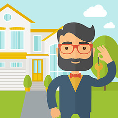 Image showing Real estate agent holding a key infront of the house
