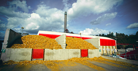 Image showing bio power plant with storage of wooden fuel against blue sky