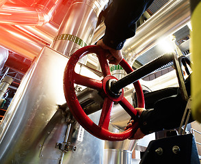 Image showing factory worker turning valve