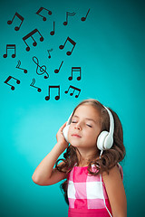 Image showing The cute cheerful little girl on orange background