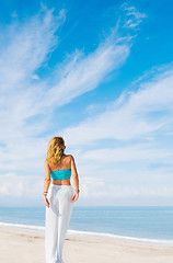 Image showing portrait of young pretty woman looking to the ocean 