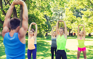 Image showing group of friends or sportsmen exercising outdoors