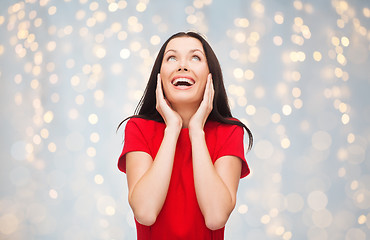 Image showing amazed laughing young woman in red dress