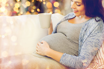 Image showing close up of pregnant woman drinking tea at home