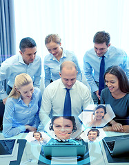 Image showing smiling business people with laptop in office