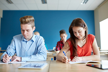 Image showing group of students with books writing school test