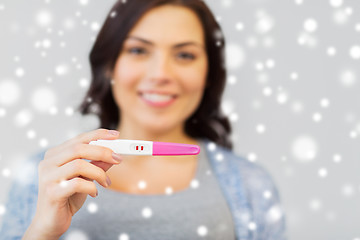 Image showing happy woman with home pregnancy test