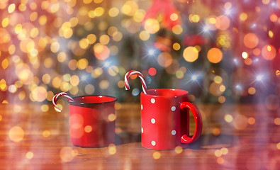 Image showing christmas candy canes in cups on wooden table