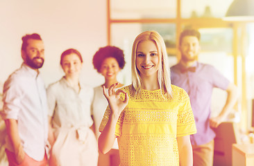 Image showing happy woman showing ok over creative office team