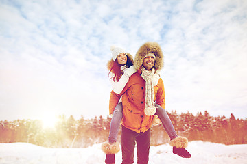 Image showing happy couple having fun over winter background