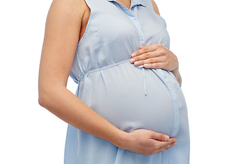 Image showing close up of pregnant woman touching her big belly