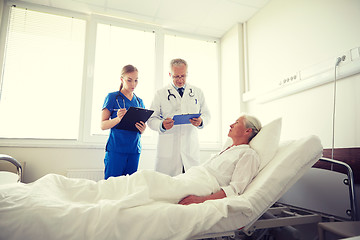 Image showing doctor and nurse visiting senior woman at hospital