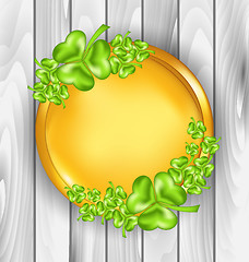 Image showing Golden coin with shamrocks. St. Patrick\'s day symbol, wooden tex