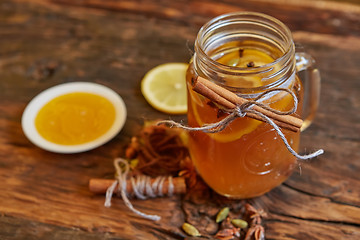 Image showing Tea with lemon and honey on the wooden background.